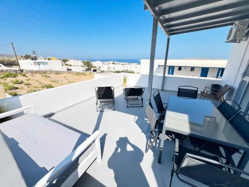 a patio with chairs and a table on a balcony at aeolian blu 2 in Parikia