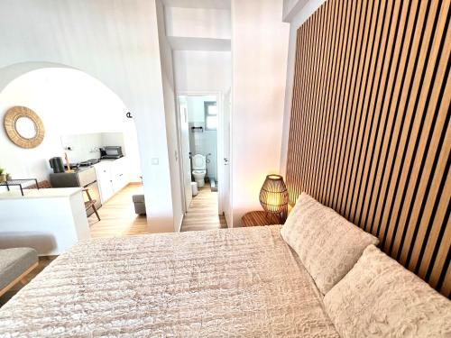 a bedroom with a bed and a living room at aeolian blu 5 in Parikia