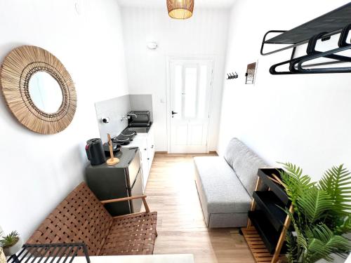 a living room with a couch and a mirror at aeolian blu 5 in Parikia