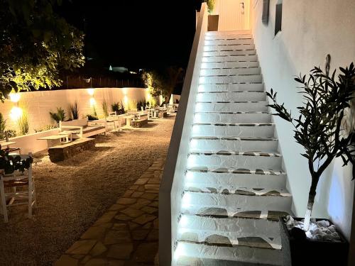 a set of stairs with benches on the side of a building at aeolian blu 5 in Parikia
