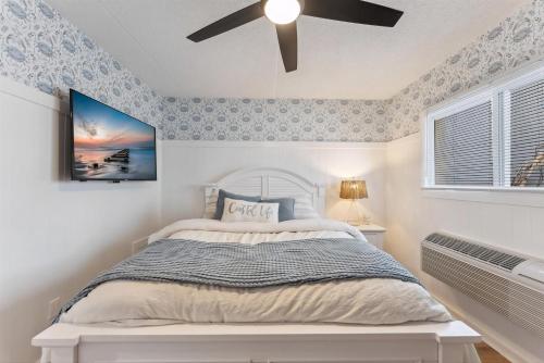 Un dormitorio con una cama y un ventilador de techo. en 301 Ocean Ave, Unit 201 - The Harbor Light, en North Wildwood