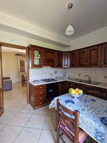 a kitchen with a table with a bowl of fruit on it at Le Terre di Sicilia in SantʼAgata di Militello