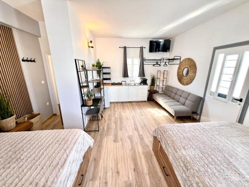 a living room with two beds and a couch at aeolian blu 11 in Parikia