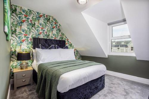 a bedroom with a large bed and a window at Room 8 ,double room with private bathroom with optional additional single room room 7 for third guest, 23 Deganwy Avenue in Llandudno