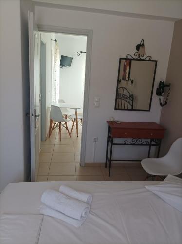 a bedroom with a bed and a table and a mirror at Magic Land in Plaka