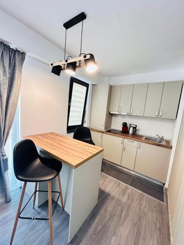 a kitchen with a wooden table and two chairs at Asi Marine Rentals in Saturn
