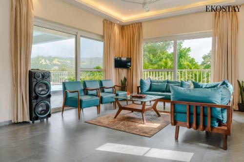 a living room with a couch and chairs and a table at EKOSTAY - Casa Den in Igatpuri