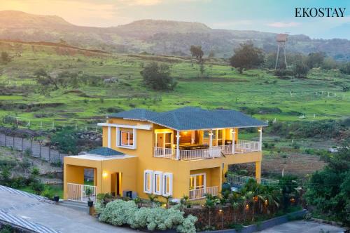 a house with a view of a field at EKOSTAY - Casa Den in Igatpuri