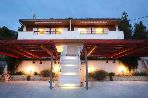a house with a staircase in front of it at Strandnahe Ferienwohnung In Podstrana in Podstrana