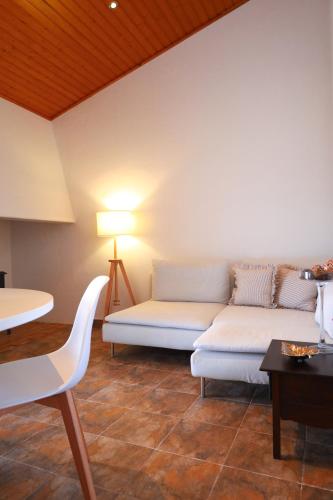 a living room with a couch and a table at Monte de São Francisco Country House in Vale de Maceira