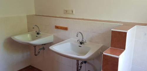 a bathroom with a white sink and a mirror at Großer Stern in Stoltebüll