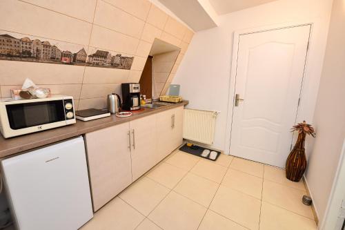 a small kitchen with a microwave on a counter at Royal Accommodation in Bucharest