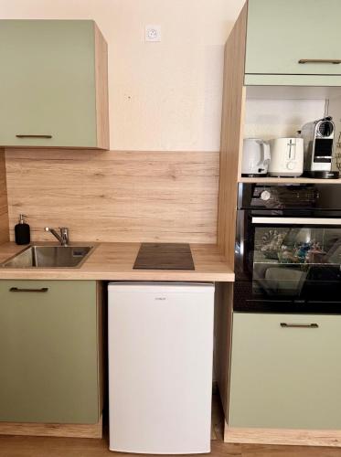 une cuisine avec un évier et un micro-ondes dans l'établissement Élégant duplex dans le centre historique, à Limoges