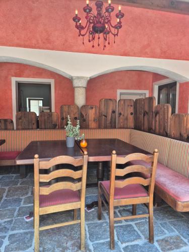 a dining room with a table and chairs and a chandelier at Lindengut Natternbach in Natternbach