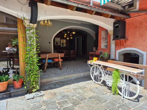 an outdoor patio with a wooden table and a bench at Lindengut Natternbach in Natternbach