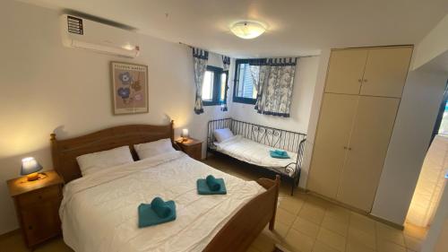 a bedroom with a bed with two blue bows on it at Barbati Olive in Barbati