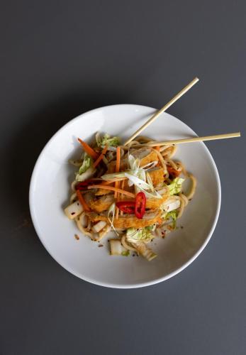 a white bowl of food with chopsticks in it at Holiday Inn Salisbury - Stonehenge by IHG in Salisbury