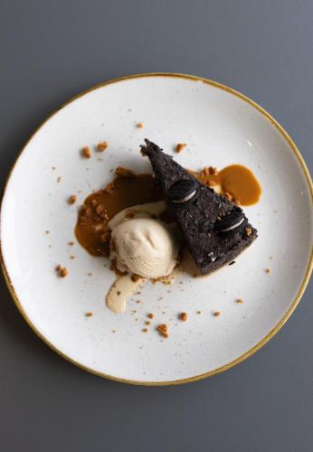 a white plate with a dessert with ice cream at Holiday Inn Salisbury - Stonehenge by IHG in Salisbury