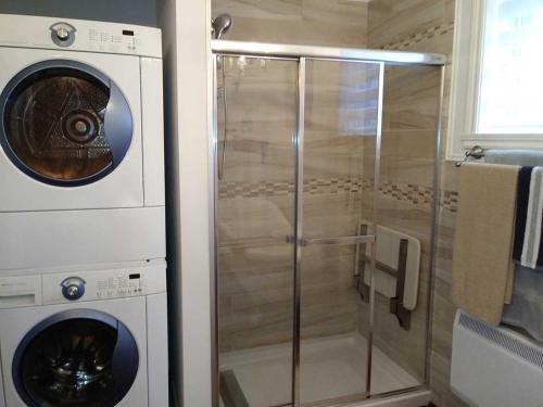 a washing machine and a washer in a bathroom at Bleu Azur 32 night Lakefront Retreat w Hot tub in Saint Adolphe D'Howard