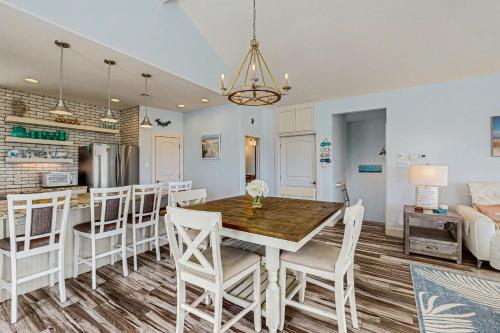 a kitchen and dining room with a table and chairs at Seaside Breezes in Padre Island