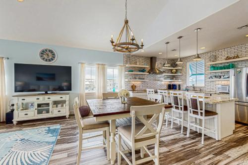 a kitchen and dining room with a table and chairs at Seaside Breezes in Padre Island