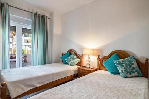 Ένα ή περισσότερα κρεβάτια σε δωμάτιο στο Charming Apartment in Quarteira - 50 m² - Terrace