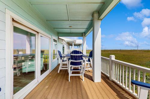 a porch with chairs and a table on it at Seaside Breezes in Padre Island