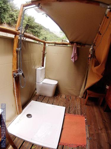 a bathroom with a toilet in a tent at Camping Trevélez in Trevélez