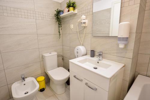 a small bathroom with a toilet and a sink at Royal Accommodation in Bucharest