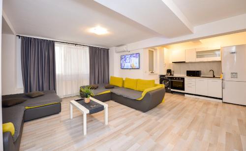 a living room with a couch and a table at Royal Accommodation in Bucharest