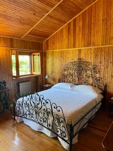 a bedroom with a bed in a wooden room at Cascina Il Dovese in Gabiano