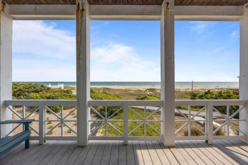 a view of the beach from the porch of a beach house at Dolphin Dreams home in Atlantic Beach