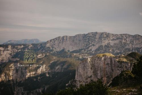 a view of a mountain with a sign on it at Pinelle Blidinje A-Frame House in Risovac