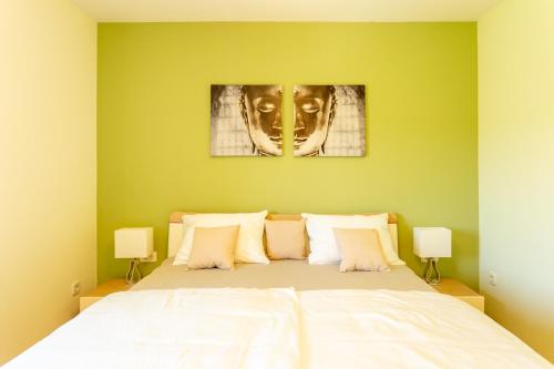 a bedroom with a bed with a mask on the wall at Apartment in the Village in Petrovče