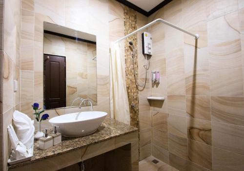 a bathroom with a sink and a shower at i Boutique Hotel in Pluak Daeng