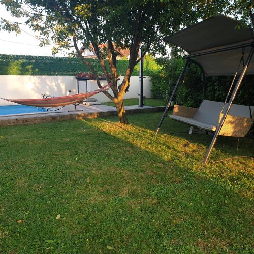 a hammock and a tent in a yard at Holiday Home Libera in Bihać