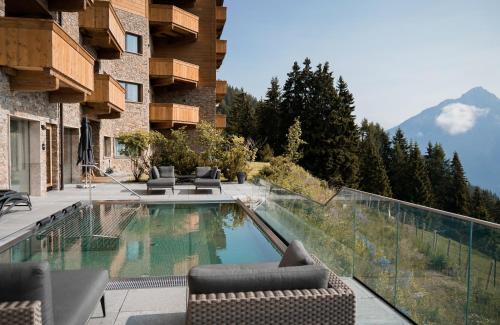 a swimming pool on the balcony of a building at Puitalm Apartments & SPA by Peak Stay in Arzl im Pitztal