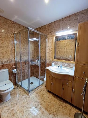 a bathroom with a shower and a toilet and a sink at Chalet con piscina privada y barbacoa in Tarragona