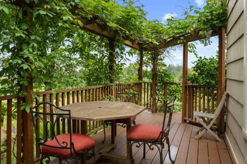 a wooden deck with a table and chairs at Hoffman Woods Estate in West Linn