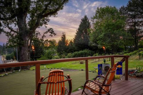 two chairs on a deck with a view of a park at Hoffman Woods Estate in West Linn