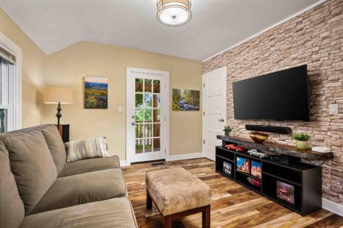 a living room with a couch and a flat screen tv at Hoffman Woods Estate in West Linn
