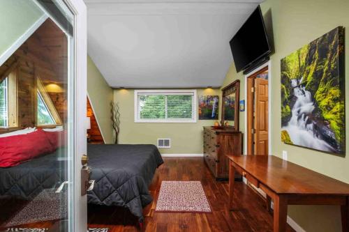a bedroom with a bed and a desk and a television at Hoffman Woods Estate in West Linn