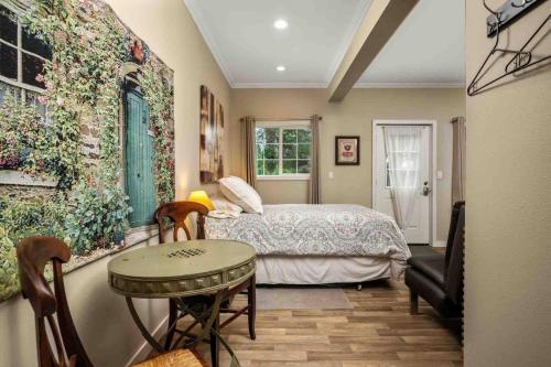 a bedroom with a bed and a table in it at Hoffman Woods Estate in West Linn