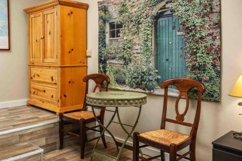 a room with a table and two chairs and a dresser at Hoffman Woods Estate in West Linn