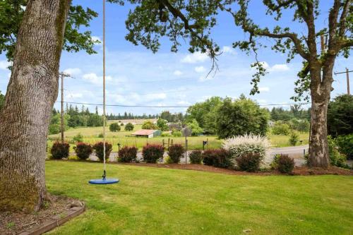 a park with a tree and a blue object in the grass at Hoffman Woods Estate in West Linn