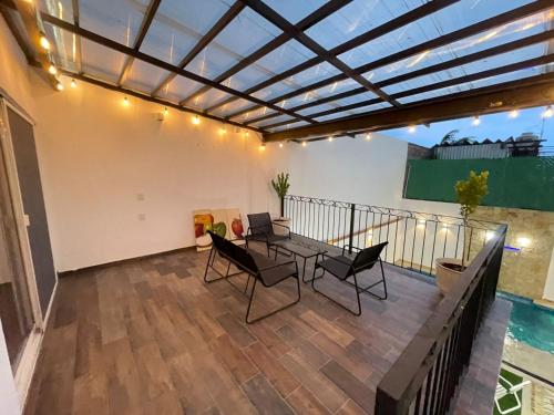 a patio with a table and chairs on a balcony at Casa Chuy pueblo mágico in Xochitepec