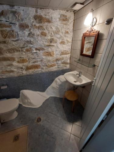 a bathroom with a sink and a toilet at Avra traditional Blue house, Elma's Houses in Alonnisos Old Town