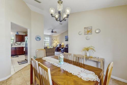 a dining room and kitchen with a table and chairs at Endless Summer in Sebastian