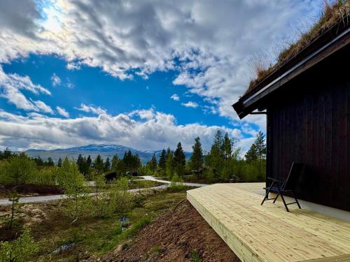 a chair sitting on the deck of a house at Brand new cabin at Hovden cross-country skiing in Hovden