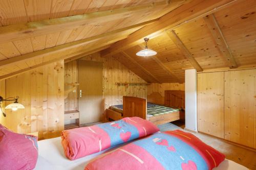 a bedroom with a bed in a room with wooden walls at Almhütte Laffaa in Rodengo